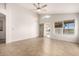 Spacious living room featuring tile floors and a ceiling fan at 11670 W Pine Mountain Ct, Surprise, AZ 85378