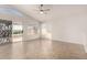 Bright living room with tile floors, sliding glass door, and vaulted ceiling at 11670 W Pine Mountain Ct, Surprise, AZ 85378