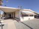 Single-wide manufactured home with carport and landscaped yard at 120 N Val Vista Dr # 81, Mesa, AZ 85213