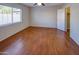 Spacious bedroom with hardwood floors and large window at 12750 W Dreyfus Dr, El Mirage, AZ 85335