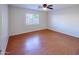 Bedroom with hardwood floors and window with blinds at 12750 W Dreyfus Dr, El Mirage, AZ 85335