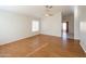 Bright living room with hardwood floors and ceiling fan at 12750 W Dreyfus Dr, El Mirage, AZ 85335