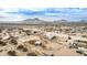 Aerial view of a home on a large lot with desert landscape and distant mountains at 13705 S 209Th Ave, Buckeye, AZ 85326