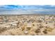 Wide aerial view of a desert landscape with a home and neighborhood at 13705 S 209Th Ave, Buckeye, AZ 85326