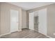 Bedroom with wood-look flooring and double doors at 13705 S 209Th Ave, Buckeye, AZ 85326