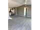 Open living room with gray walls and wood-look floors at 13705 S 209Th Ave, Buckeye, AZ 85326