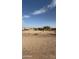 Empty lot with desert landscape and distant home at 13705 S 209Th Ave, Buckeye, AZ 85326