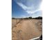 Large desert lot with a home in the distance at 13705 S 209Th Ave, Buckeye, AZ 85326