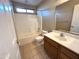 Clean bathroom with tub, shower, and wood vanity at 13943 S Amado Blvd, Arizona City, AZ 85123