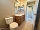 Clean bathroom with single sink vanity, toilet and mirror at 13943 S Amado Blvd, Arizona City, AZ 85123