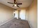 Bedroom with ceiling fan and sliding door closet at 13943 S Amado Blvd, Arizona City, AZ 85123