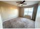 Bright bedroom with window and ceiling fan at 13943 S Amado Blvd, Arizona City, AZ 85123