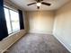 Well-lit bedroom with large window and ceiling fan at 13943 S Amado Blvd, Arizona City, AZ 85123