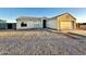 House exterior showcasing a two-car garage and gravel driveway at 13943 S Amado Blvd, Arizona City, AZ 85123