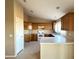 Kitchen with wooden cabinets and white appliances at 13943 S Amado Blvd, Arizona City, AZ 85123