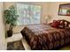 Cozy bedroom with patterned bedding and tiled floors at 14300 W Bell Rd # 5, Surprise, AZ 85374