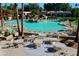 Inviting pool with tables, chairs, and a rock waterfall feature at 14300 W Bell Rd # 5, Surprise, AZ 85374