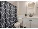 Clean bathroom with white vanity and gray shower curtain at 1510 E Ironwood Dr, Buckeye, AZ 85326