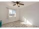 Bright bedroom with ceiling fan and wood-look floors at 1510 E Ironwood Dr, Buckeye, AZ 85326