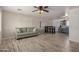 Open living room with wood-look floors and view into the kitchen at 1510 E Ironwood Dr, Buckeye, AZ 85326