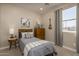 Cozy bedroom with twin bed, dresser, and window at 17066 W Seldon Ln, Waddell, AZ 85355