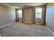 Bright bedroom with neutral carpet, ample natural light, and large windows at 17066 W Seldon Ln, Waddell, AZ 85355