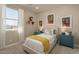 Charming bedroom with twin bed and teal dresser at 17066 W Seldon Ln, Waddell, AZ 85355