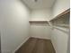 Walk-in closet with shelving and rod, providing ample storage space at 17066 W Seldon Ln, Waddell, AZ 85355