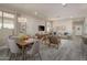 Open concept dining room with wood table and mid-century modern chairs at 17066 W Seldon Ln, Waddell, AZ 85355