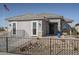 One-story home with gray exterior, a white garage door, and a black metal fence at 17066 W Seldon Ln, Waddell, AZ 85355