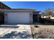 Charming single-story home with a two-car garage and low-maintenance landscaping at 17066 W Seldon Ln, Waddell, AZ 85355