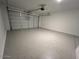 Spacious two-car garage with epoxy flooring and ample room for vehicles and storage at 17066 W Seldon Ln, Waddell, AZ 85355