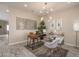 Modern home office with a wood desk, stylish chair, and geometric wall art at 17066 W Seldon Ln, Waddell, AZ 85355