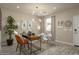 Bright home office with wood desk and mid-century modern chairs at 17066 W Seldon Ln, Waddell, AZ 85355