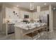 Modern kitchen with white cabinets, quartz countertops, and a breakfast bar at 17066 W Seldon Ln, Waddell, AZ 85355