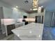 Modern kitchen with stainless steel appliances, a center island, and stylish lighting at 17066 W Seldon Ln, Waddell, AZ 85355