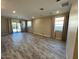 Spacious living room featuring recessed lighting, wood-look flooring, and sliding glass doors at 17066 W Seldon Ln, Waddell, AZ 85355