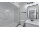 Bathroom with marble-style tile, white vanity, and black fixtures at 2046 E Alder Cir, Mesa, AZ 85204