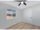 Bedroom with ceiling fan, window with blinds, and wood-look flooring at 2046 E Alder Cir, Mesa, AZ 85204