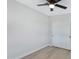 Bright bedroom with ceiling fan, light wood flooring, and double door closet at 2046 E Alder Cir, Mesa, AZ 85204