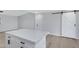 White kitchen island with quartz countertop, black hardware, and adjacent barn door at 2046 E Alder Cir, Mesa, AZ 85204