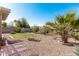 Landscaped backyard with gravel, grass, and various plants at 2135 N St Pedro Ave, Casa Grande, AZ 85122