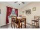 Dining area with wooden table and chairs, and red curtains at 2135 N St Pedro Ave, Casa Grande, AZ 85122