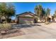 House exterior showcasing a two-car garage and mature trees at 2135 N St Pedro Ave, Casa Grande, AZ 85122