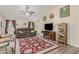 Living room featuring a brown sofa, hardwood floors, and a fireplace at 2135 N St Pedro Ave, Casa Grande, AZ 85122