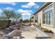 Landscaped backyard with a flagstone patio and built-in seating at 2223 W Hazelhurst Ct, Anthem, AZ 85086