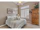 Spacious bedroom with a queen-size bed and wood dresser at 2223 W Hazelhurst Ct, Anthem, AZ 85086