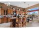 Gourmet kitchen boasting granite counters and island with wine rack at 2223 W Hazelhurst Ct, Anthem, AZ 85086