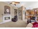 Cozy living room with fireplace and view of kitchen at 2223 W Hazelhurst Ct, Anthem, AZ 85086