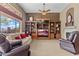 Relaxing living room with a built-in entertainment center and fireplace at 2223 W Hazelhurst Ct, Anthem, AZ 85086